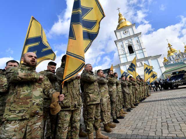 <p>Veterans of the Azov Battalion, who took part in the war with Russia-backed separatists in the east of Ukraine, salute during a mass ‘No Surrender’ rally in Kyiv in March 2020</p>