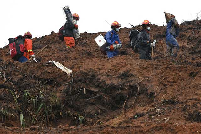 <p>Rescue workers comb through the site of where China Eastern flight MU5375 crashed on March 21, near Wuzhou in southwestern Chinas Guangxi province</p>
