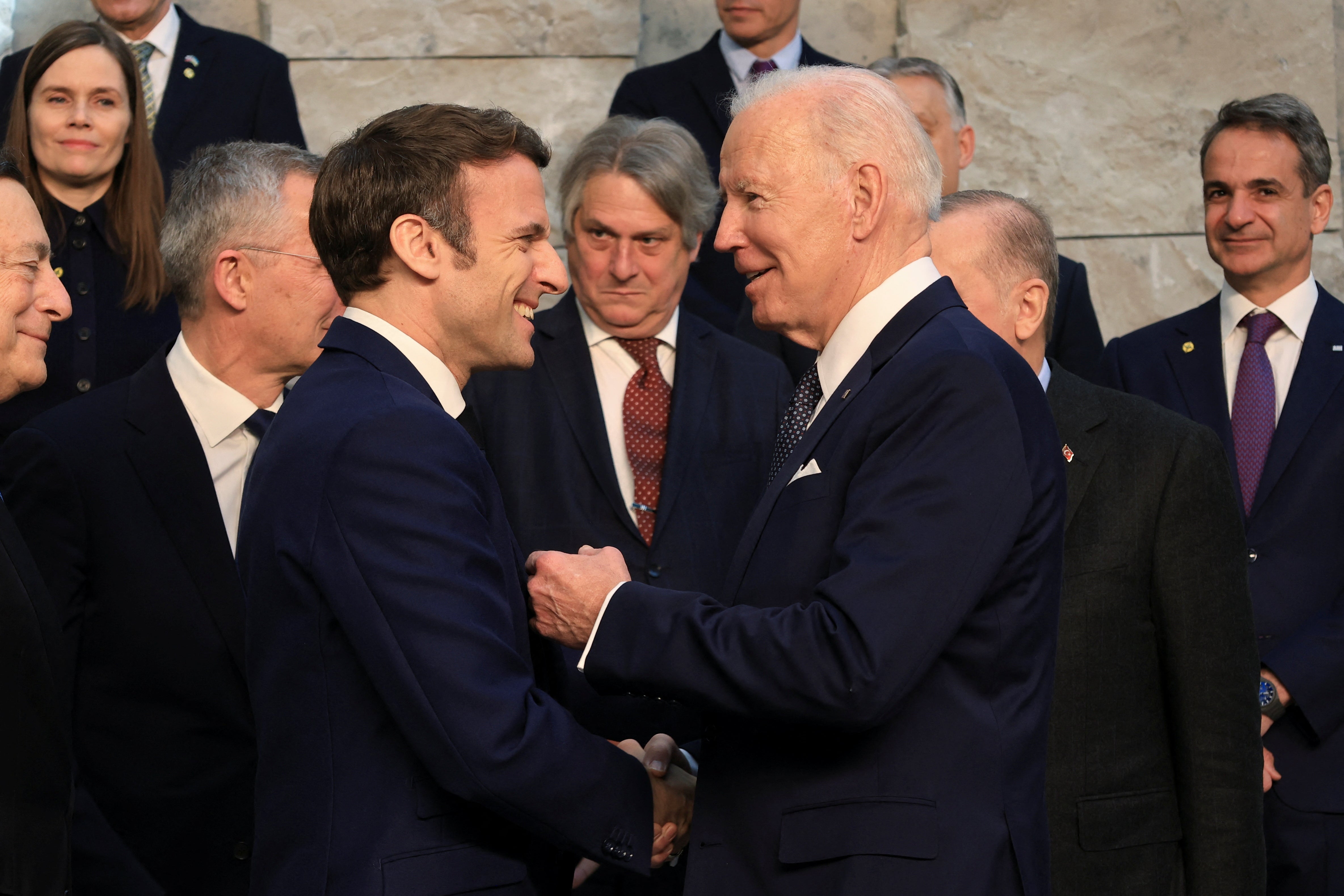 US President Joe Biden and Mr Macron speak during a family photo opportunity before a Nato summit to discuss Russia’s invasion of Ukraine at the alliance’s headquarters in Brussels, Belgium