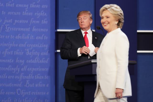 <p>Democratic presidential nominee former Secretary of State Hillary Clinton walks off stage as Republican presidential nominee Donald Trump looks on during the third U.S. presidential debate at the Thomas & Mack Center on October 19, 2016 in Las Vegas, Nevada</p>