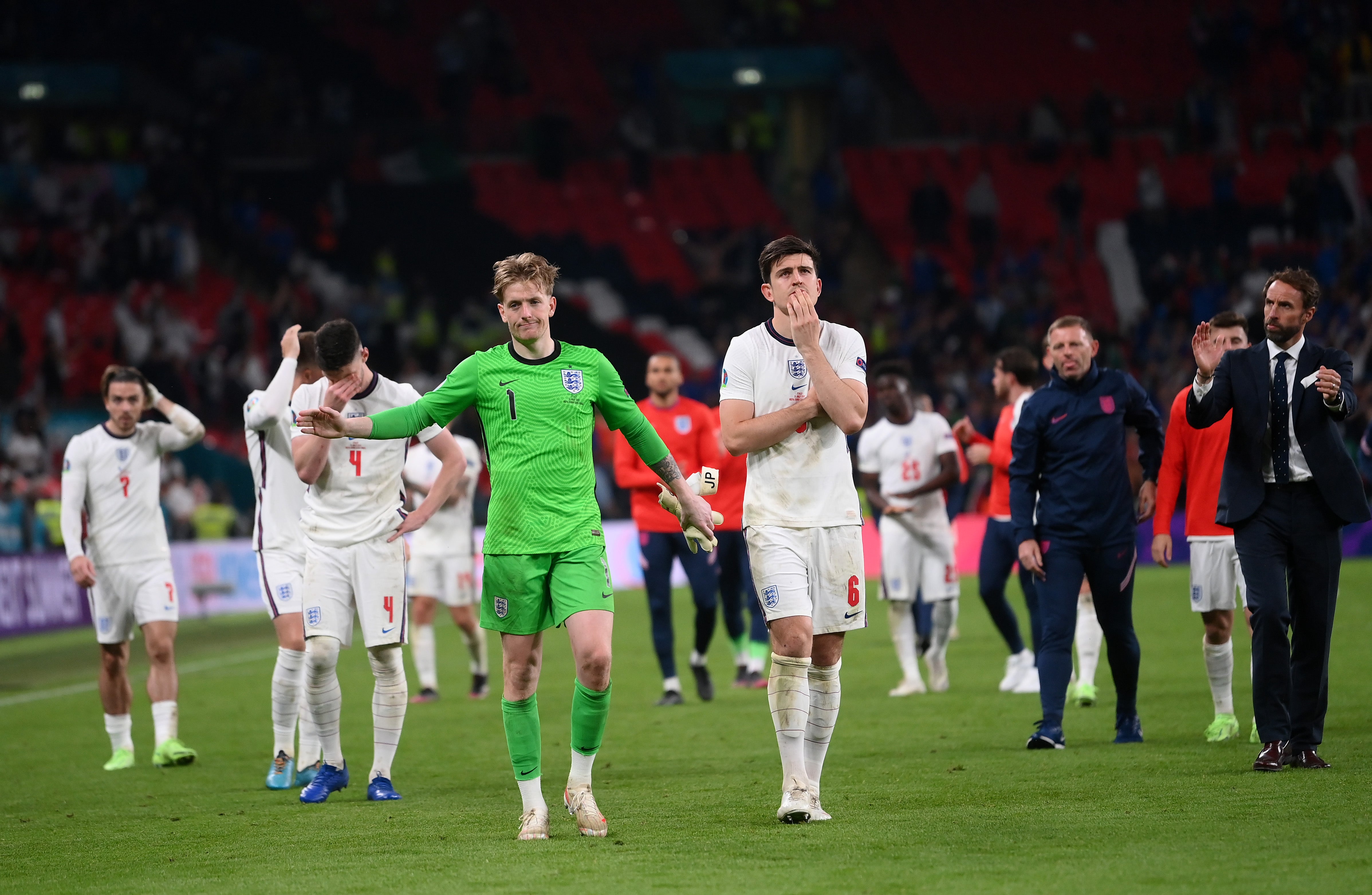 Jordan Pickford and Harry Maguire of England show their disappointment after defeat on penalties to Italy at Euro 2020