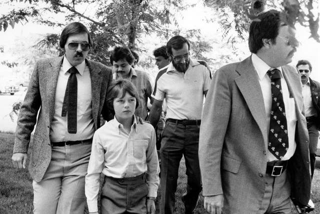 <p>Walter Polovchak (center) walking into juvenile court for a trial about his custody on 4 August 1980 </p>