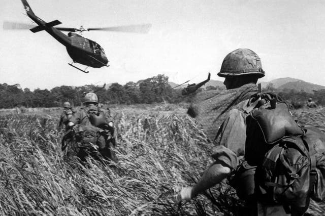 <p>US soldiers are evacuated from a Vietcong position in December 1965 </p>