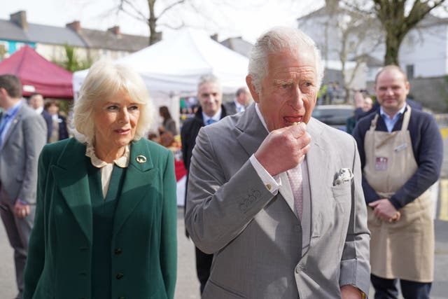 Charles and Camilla sample some food during a visit to Cahir Farmers’ Market (Brian Lawless/PA)