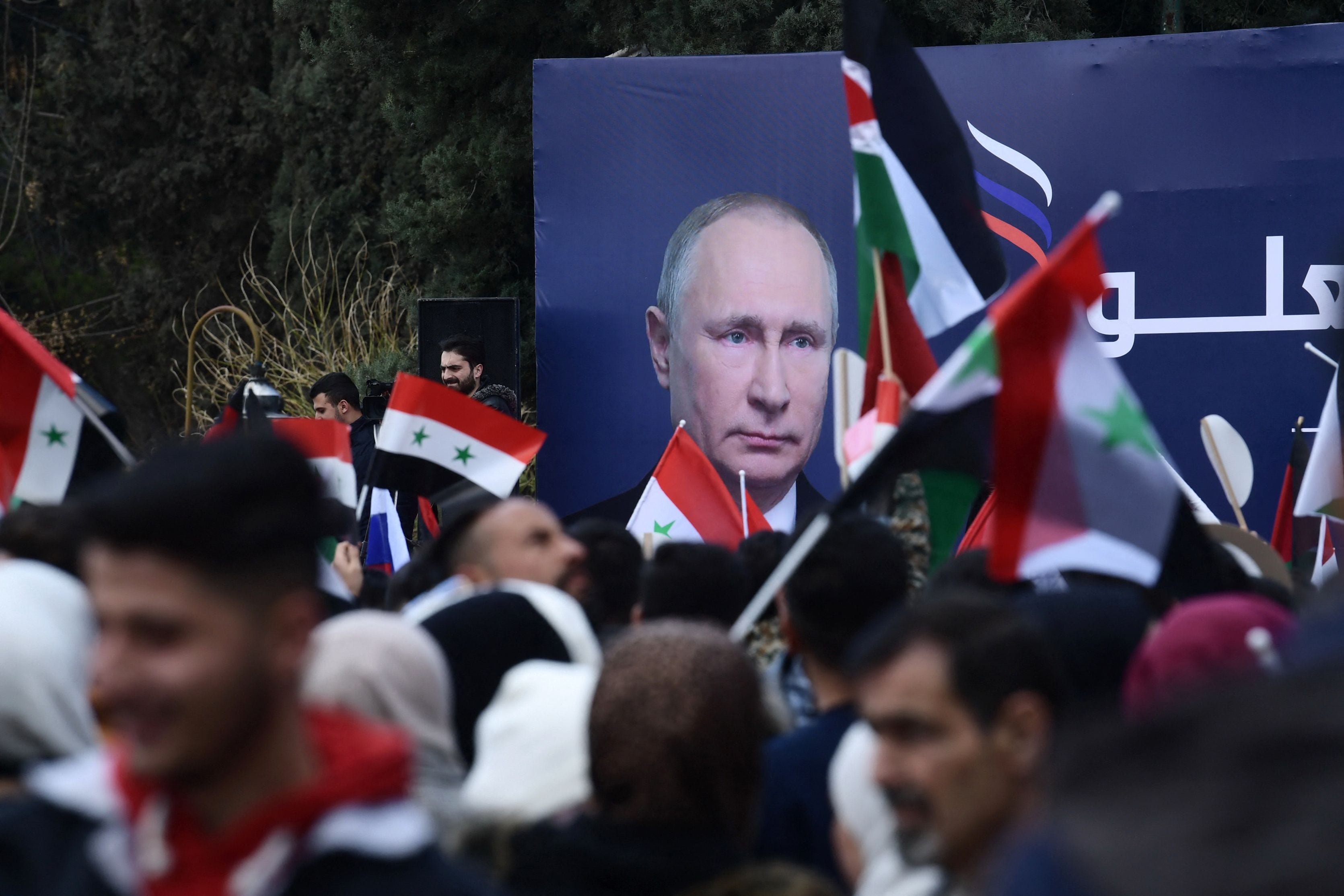 Syrian students wave Syrian, Russian and Palestinian flags in a pro-Russian demo