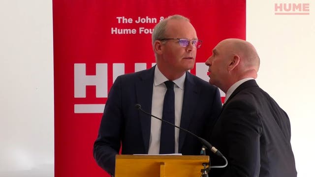 Simon Coveney’s speech was halted and he was ushered from the room due to the security alert (Hume Foundation/PA)