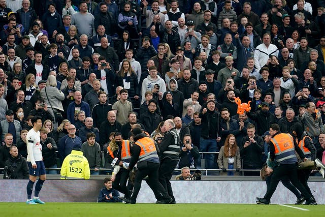 <p>Nathan McGovern is dragged from the pitch at the Tottenham Hotspur v West Ham game in London on Sunday 20 March</p>