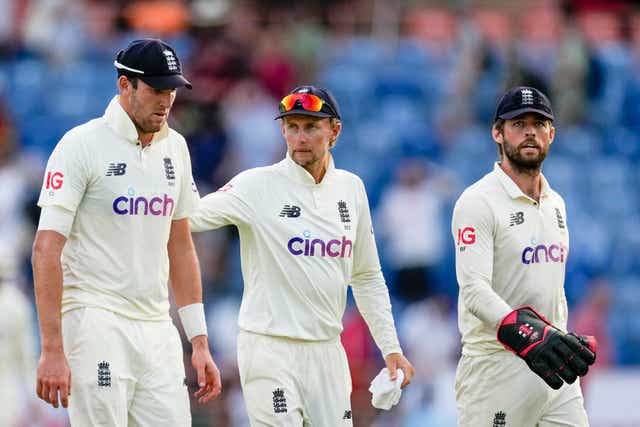 <p>England’s captain Joe Root, centre, leaves the field with teammates Craig Overton, left, and Ben Foakes</p>