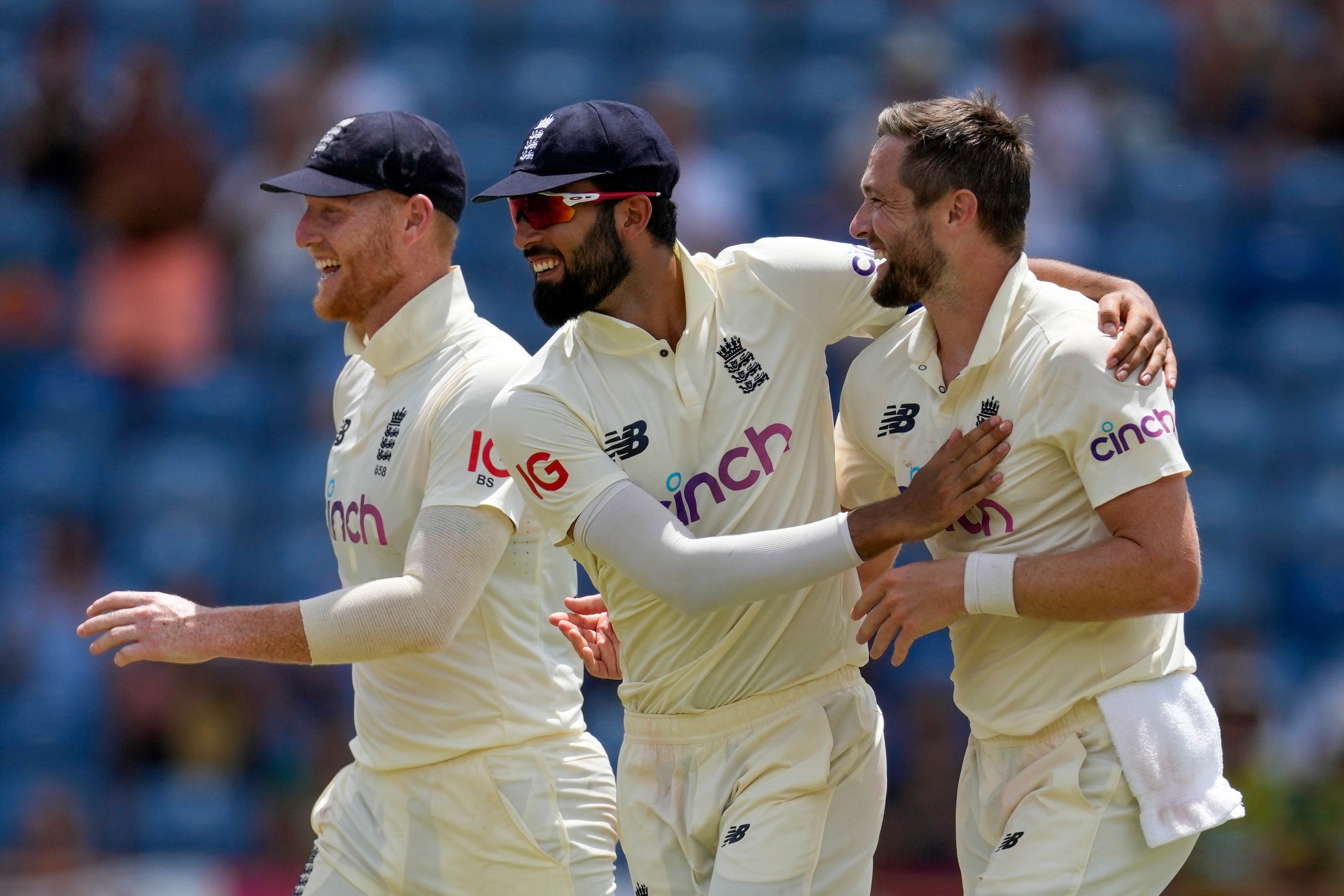 Chris Woakes, right, celebrates the wicket of Jason Holder (Ricardo Mazalan/AP)