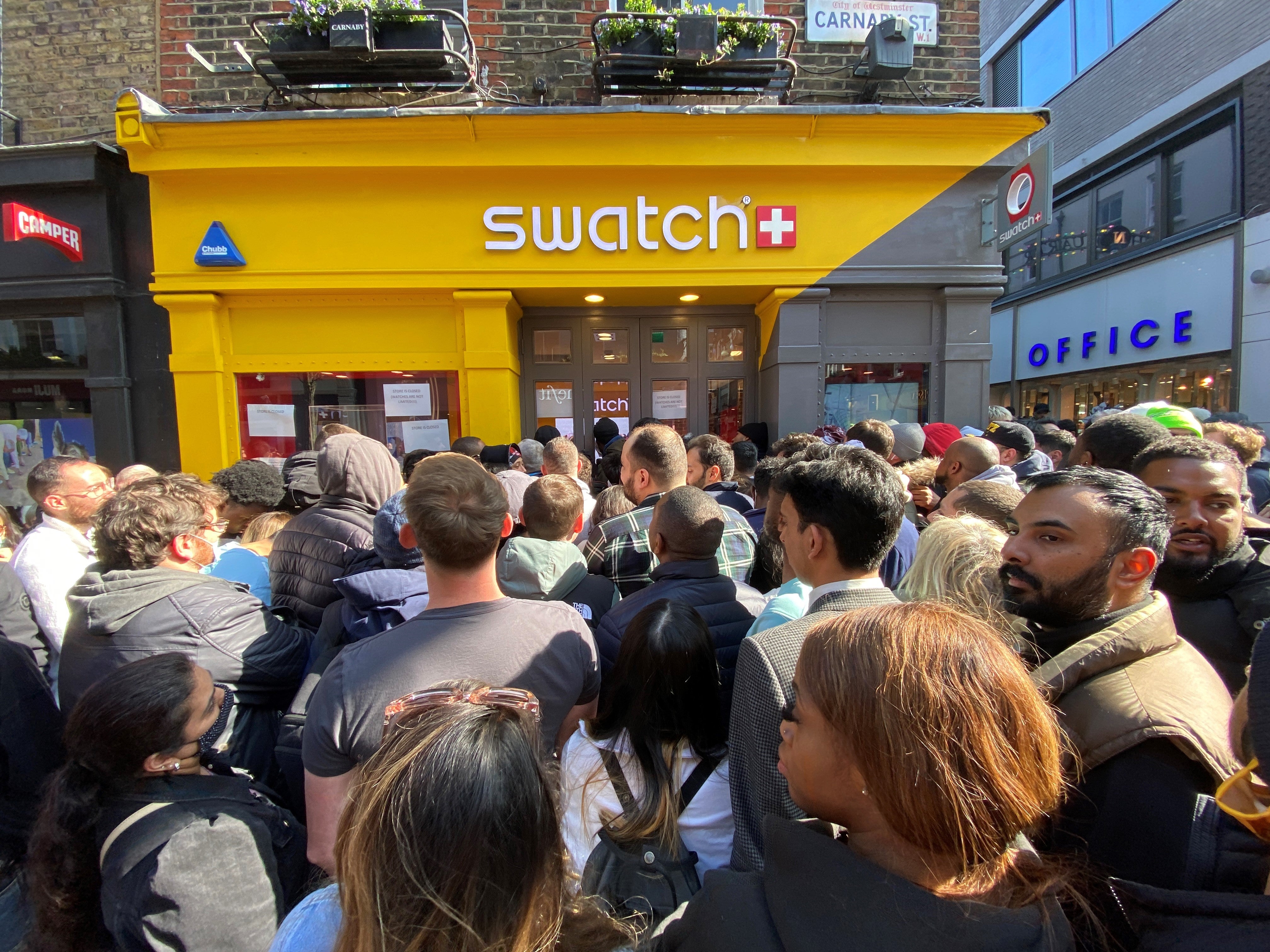 Customers crowded outside the Swatch store on Carnaby Street, central London, for the launch of the MoonSwatch collection (Yui Mok/PA)