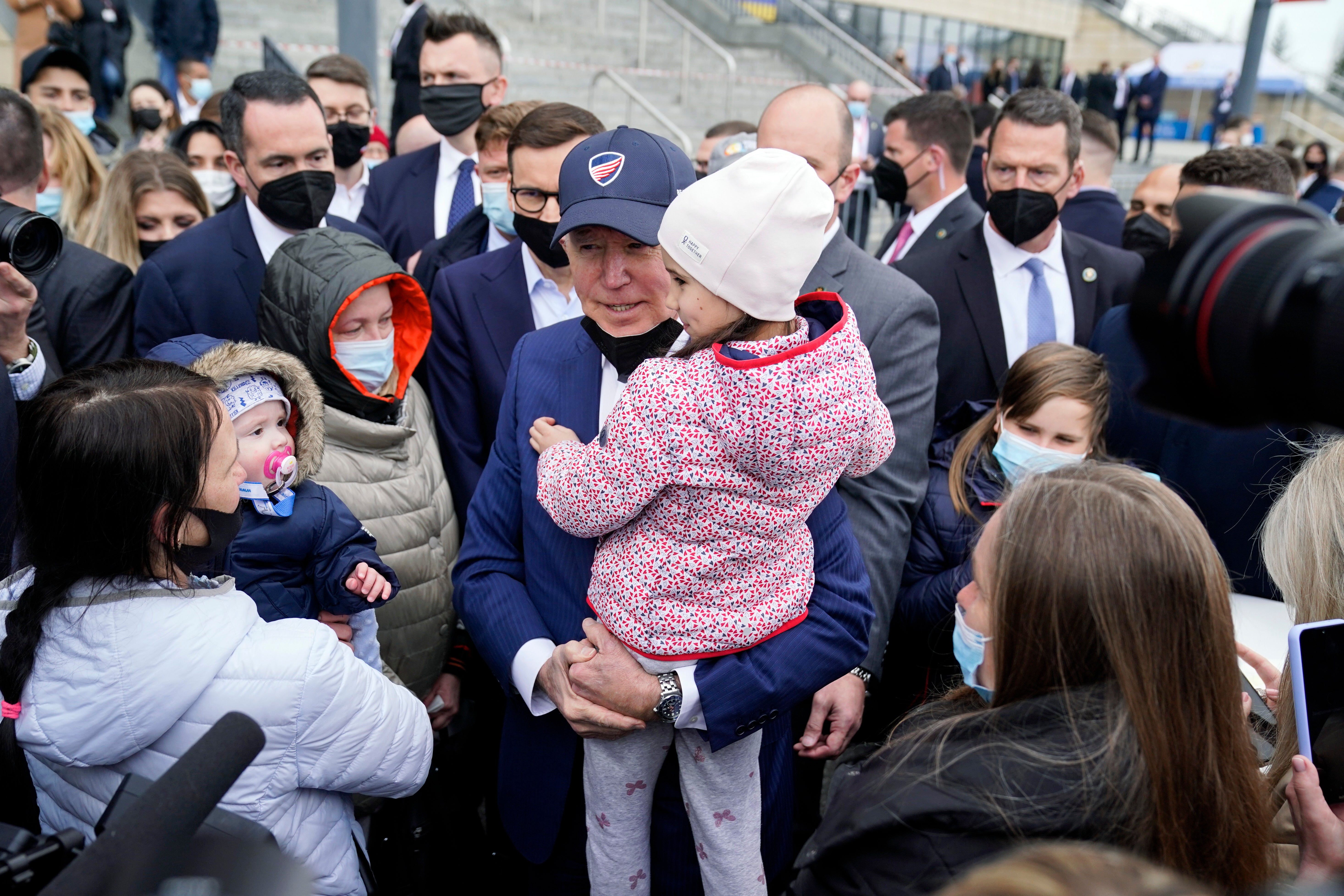 President Joe Biden met with Ukrainian refugees and humanitarian aid workers during a visit to PGE Narodowy Stadium on Saturday
