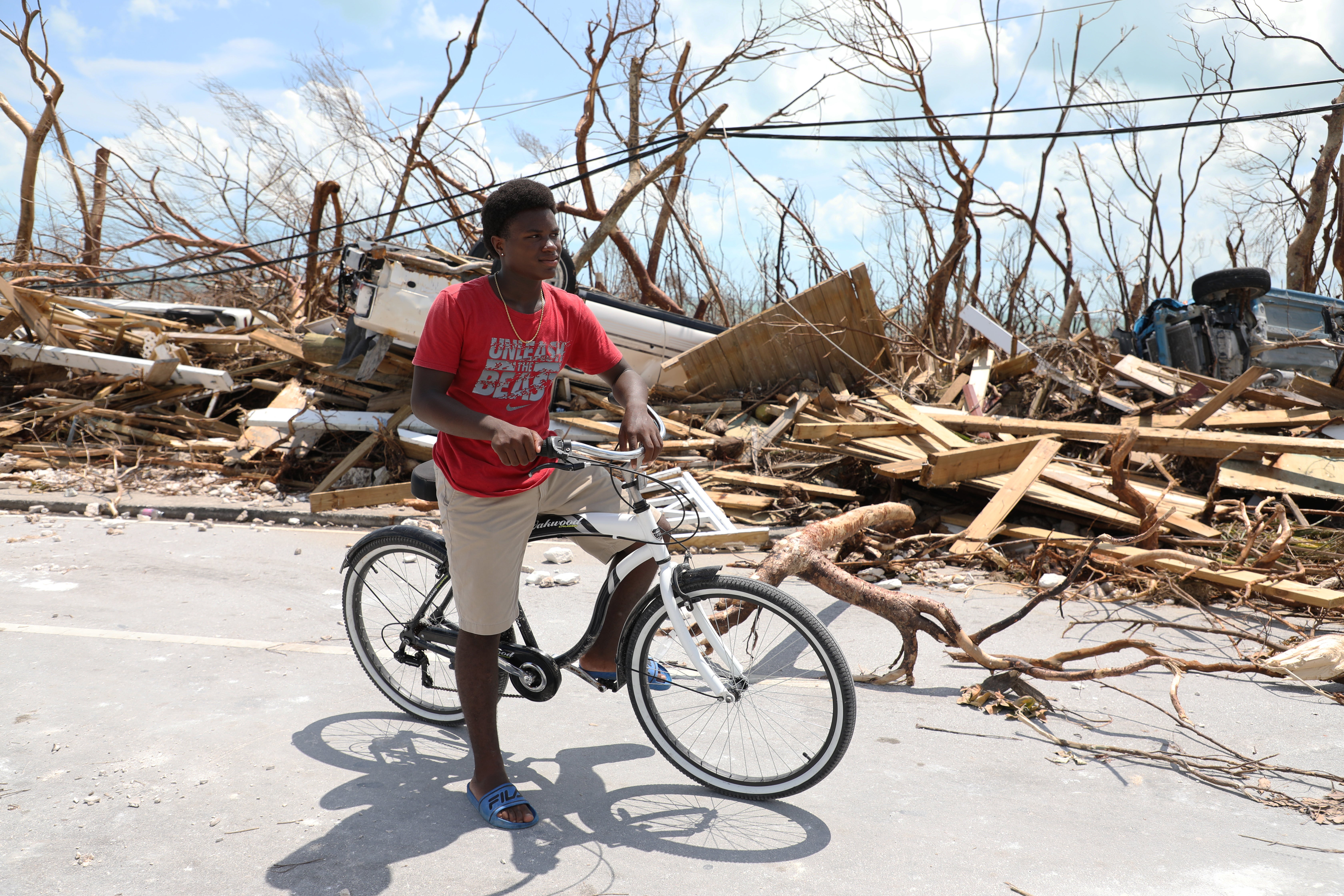 Benson Etienne riding his bicycle around the hurricane-hit Marsh Harbour, on Abaco Island in the Bahamas (Manuel Moreno Gonzalez/Unicef)
