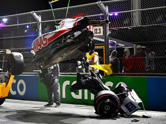 <p>Mick Schumacher’s car is lifted off the track</p>
