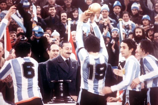 <p>Argentine dictator Jorge Rafael Videla presents the World Cup to Argentina captain Daniel Passarella on 25 June 1978. Other players pictured include former Spurs player Osvaldo Ardiles (second right). Argentina beat Holland 3-1 in the final</p>