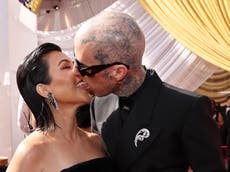 Kourtney Kardashian and Travis Barker match in black as they kiss on Oscars red carpet