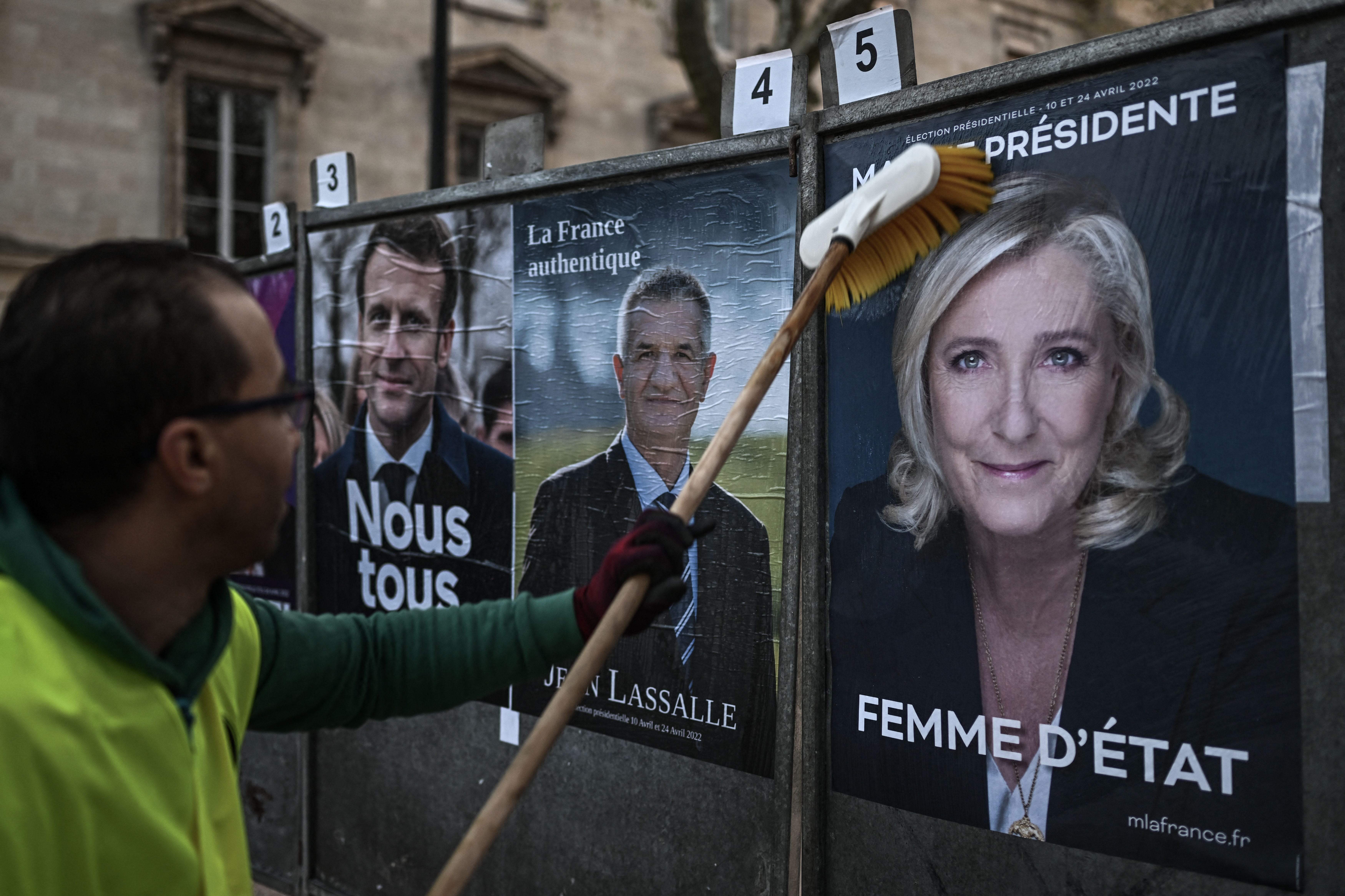 French presidential candidates’ official campaign posters are put up in Bordeaux on Monday