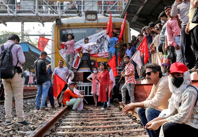 <p>Demonstrators block a passenger train during a two-day long strike in Kolkata</p>