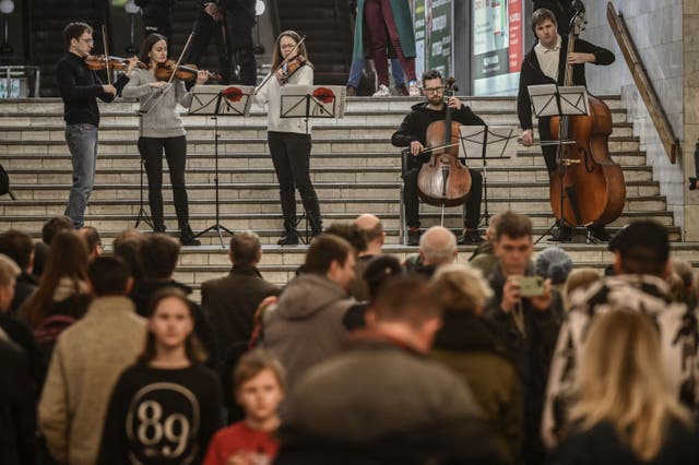 <p>Musicians play for people living in a metro station used as a bomb shelter in Kharkiv, 26 March 2022</p>