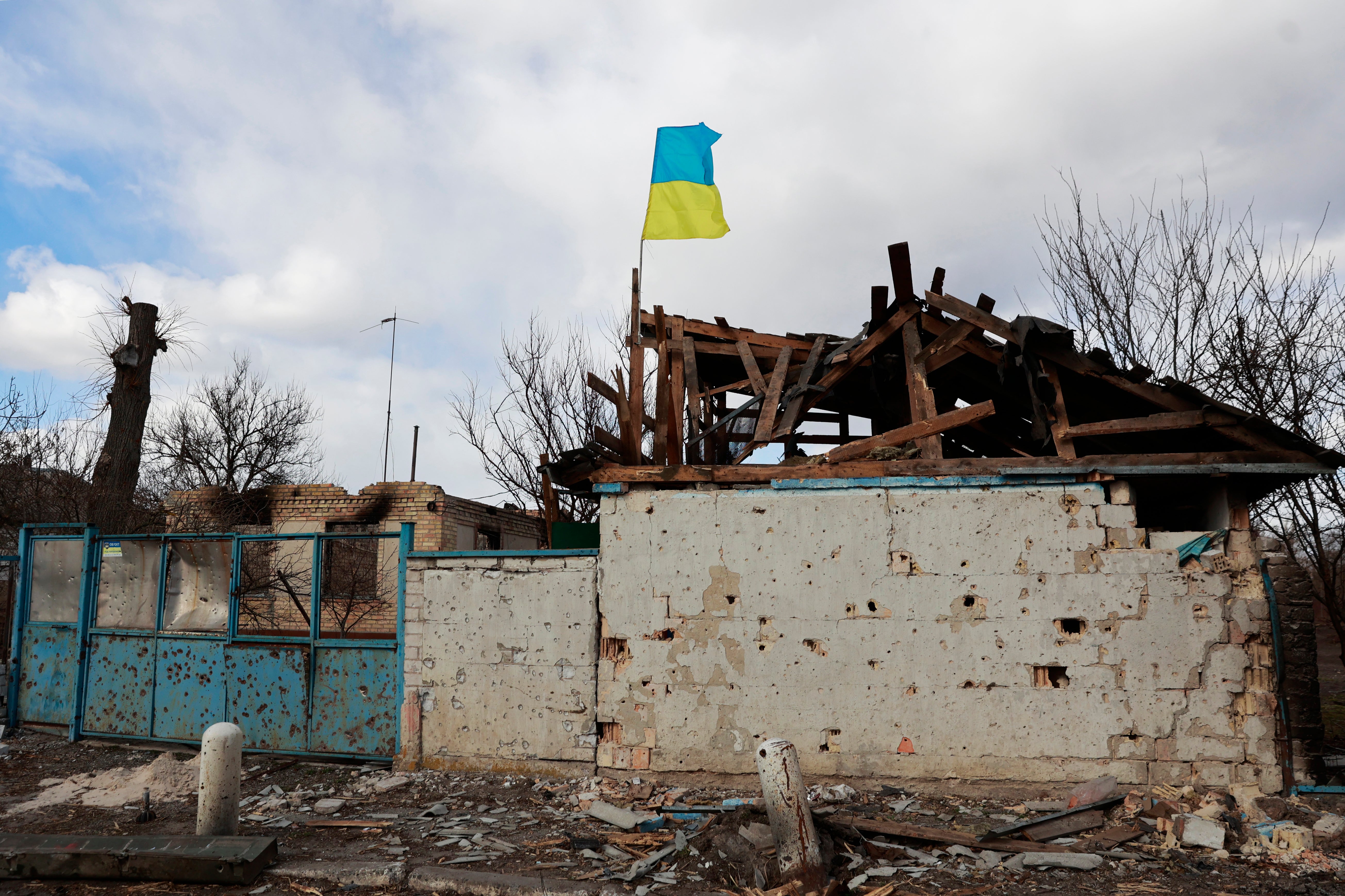 A Ukrainian flag is installed on an apartment building damaged by fighting between Russian and Ukrainian troops in a village of Lukyanivka, Kyiv region, Ukraine (AP Photo)