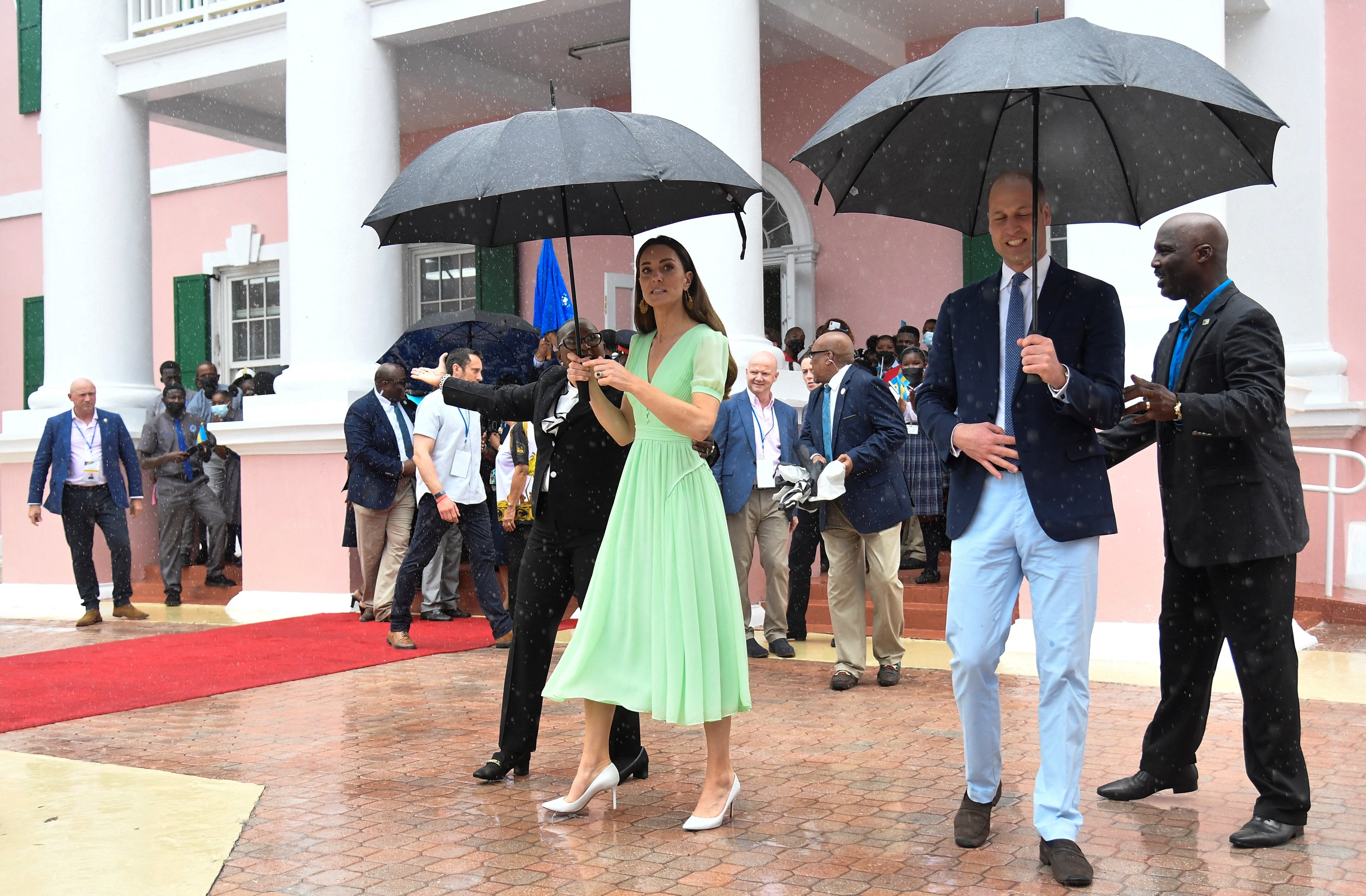 The Duke and Duchess of Cambridge go for a walkabout in the rain to meet locals in Nassau (Toby Melville/PA)