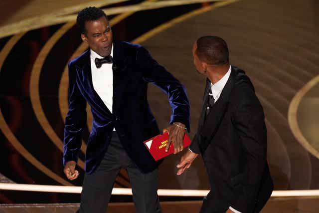 Chris Rock, left, being hit on stage by Will Smith while presenting the Oscars got sports stars talking on Monday (Chris Pizzello/AP)