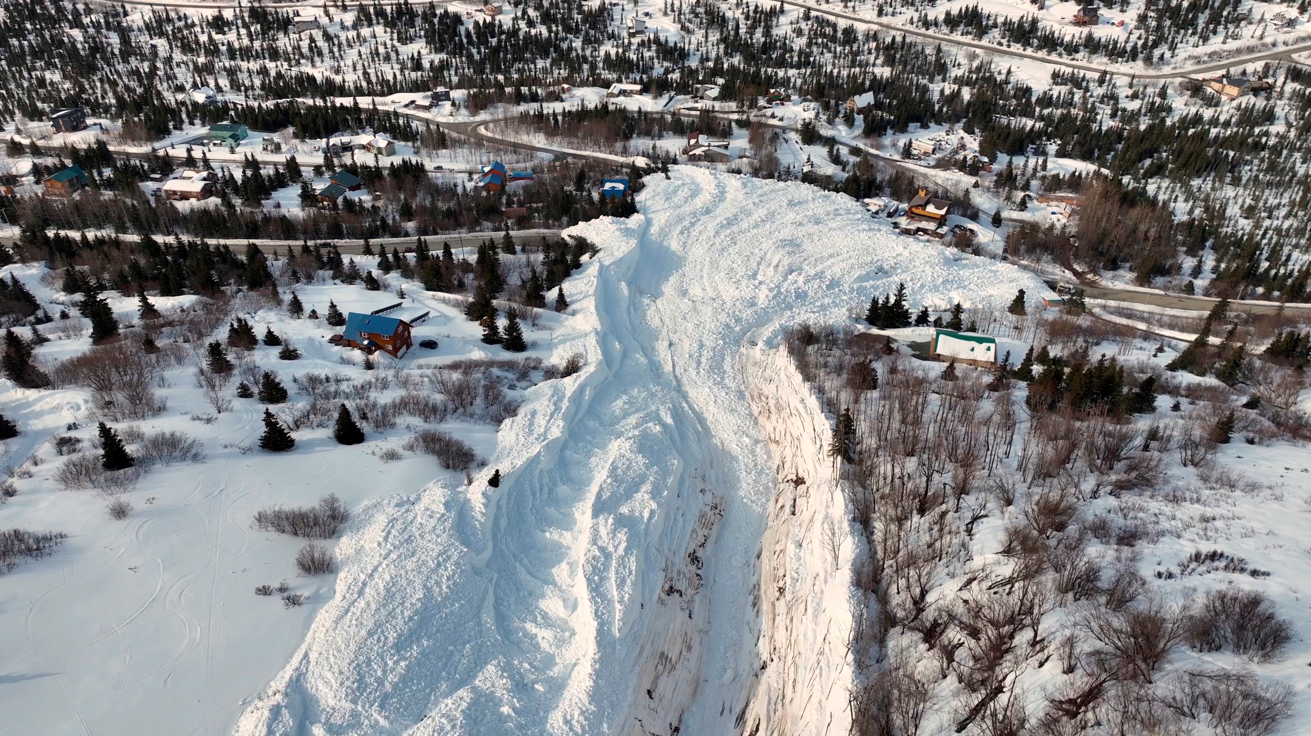 The aftermath of an avalanche down a mountainside at Hiland Road in Anchorage, Alaska