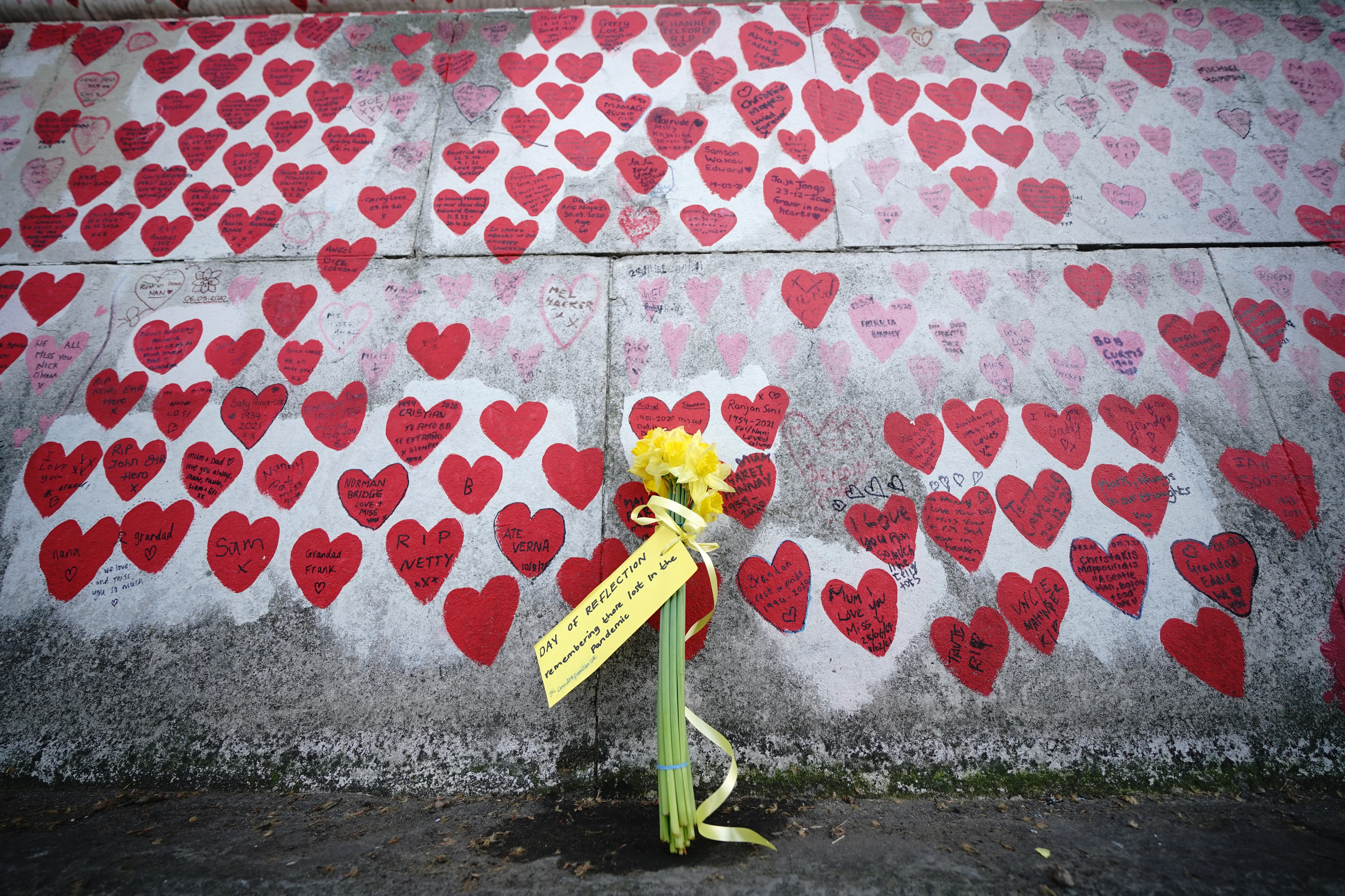 Flowers by the Covid memorial wall in Westminster in central London (Yui Mok/PA)