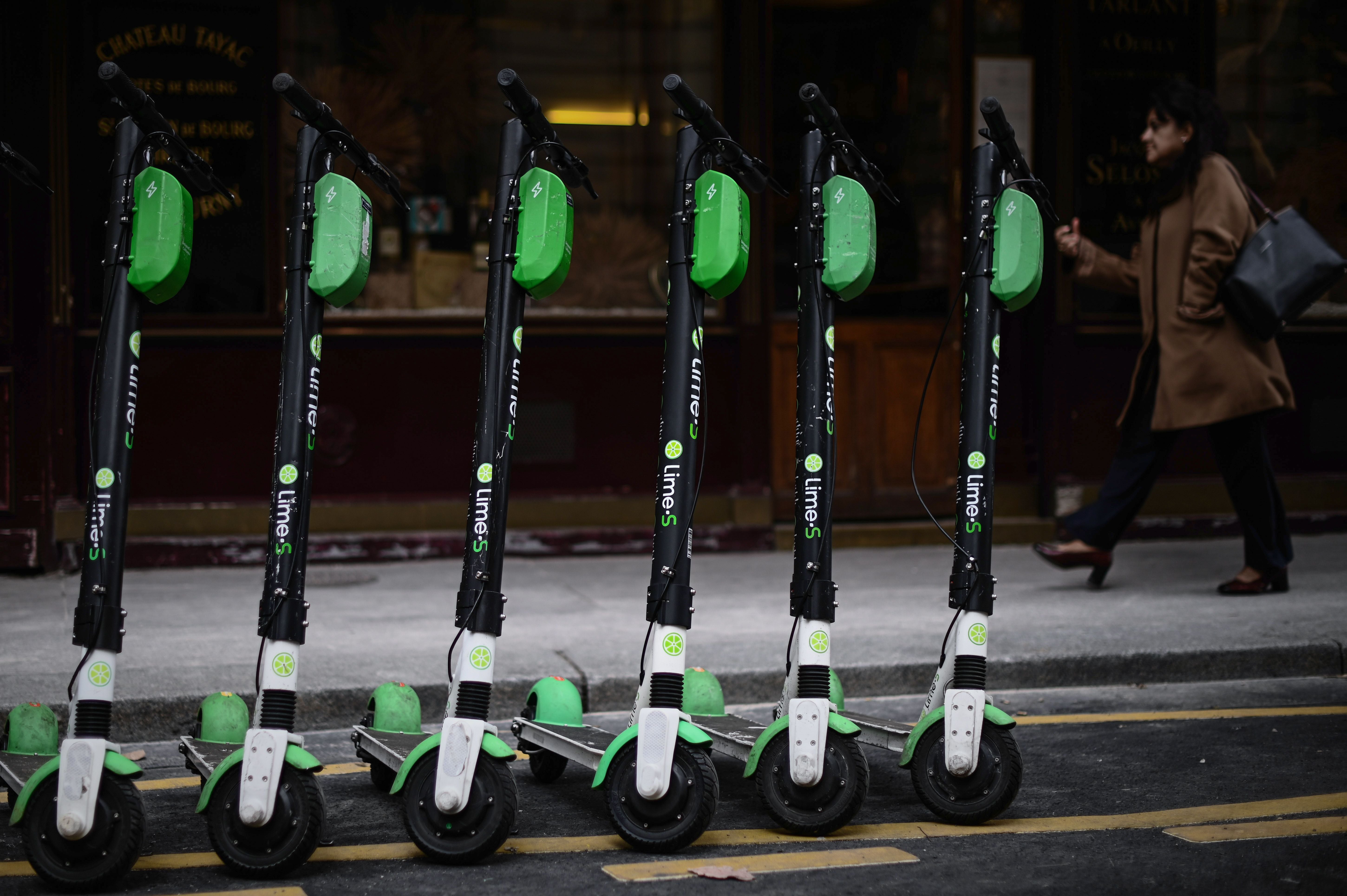 Electric scooters parked in a Paris street.