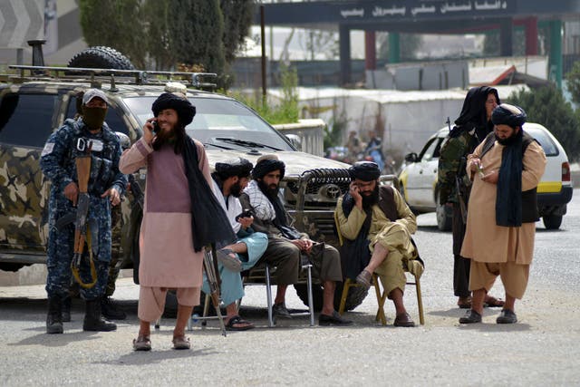 <p>Members of the Taliban operate a road checkpoint in Kandahar</p>