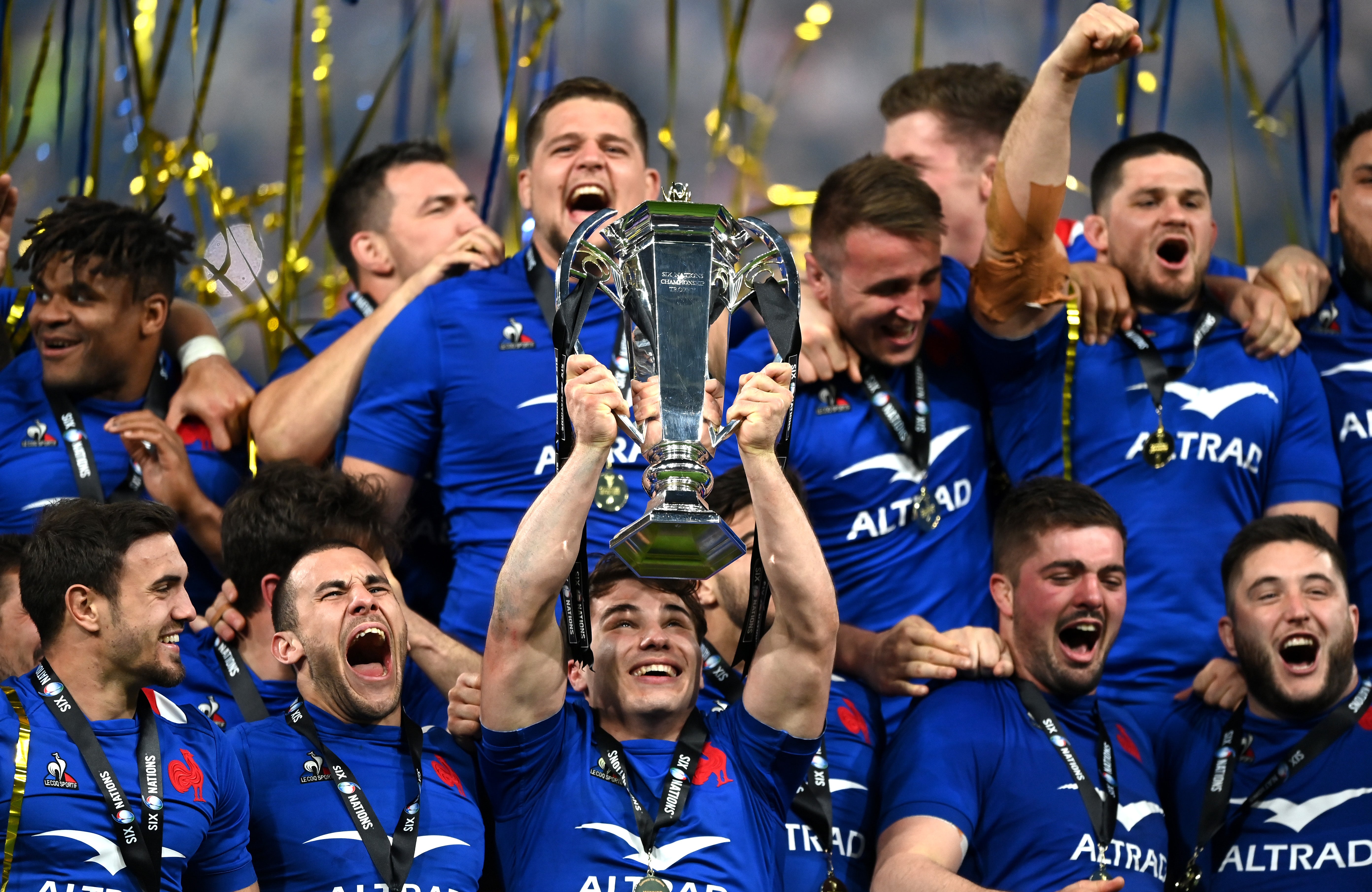 Antoine Dupont of France lifts the Six Nations Trophy with teammates