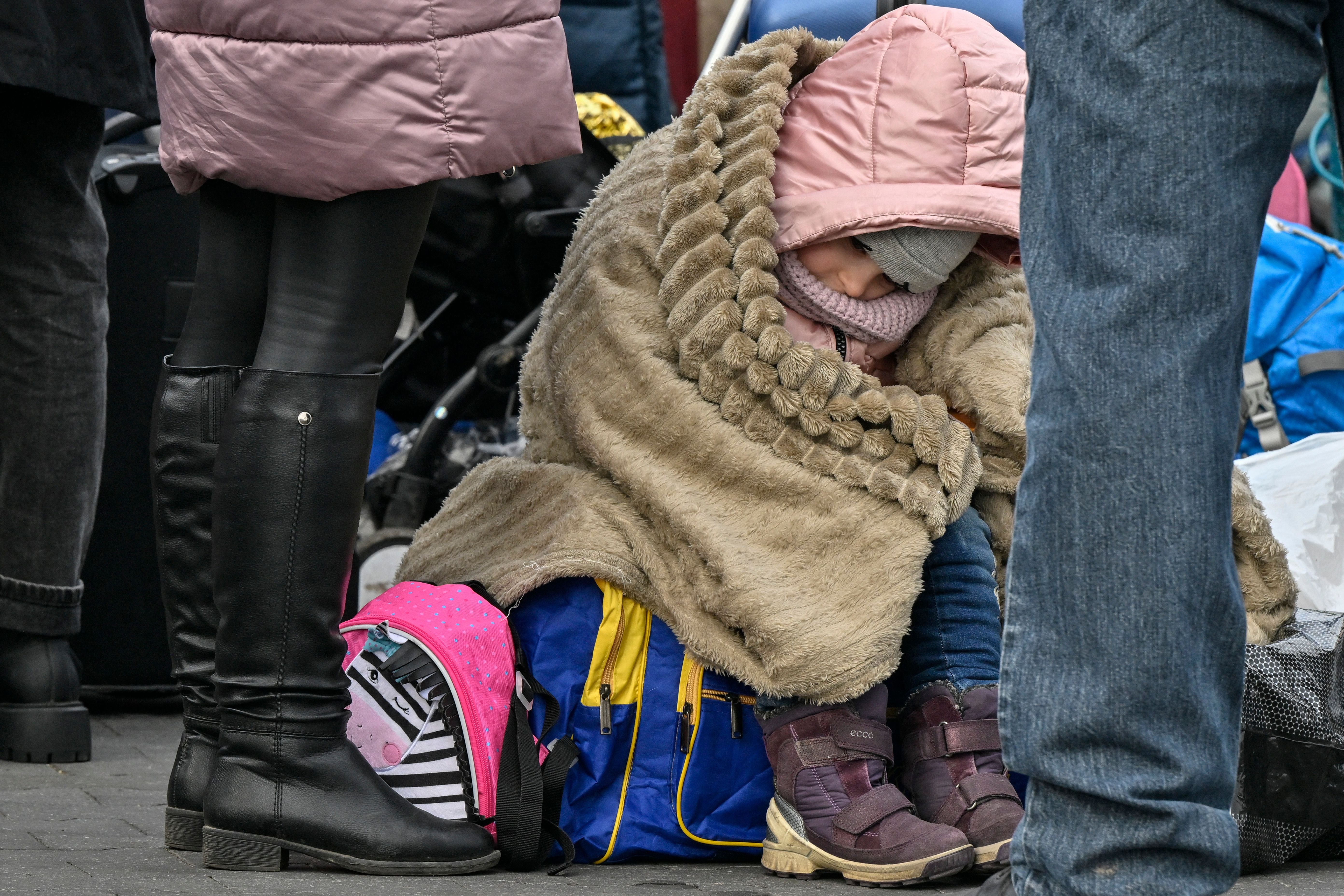 A Ukrainian child waits to be relocated from the temporary shelter for refugees in a former shopping centre between the Ukrainian border and the Polish city of Przemysl, 8 March 2022