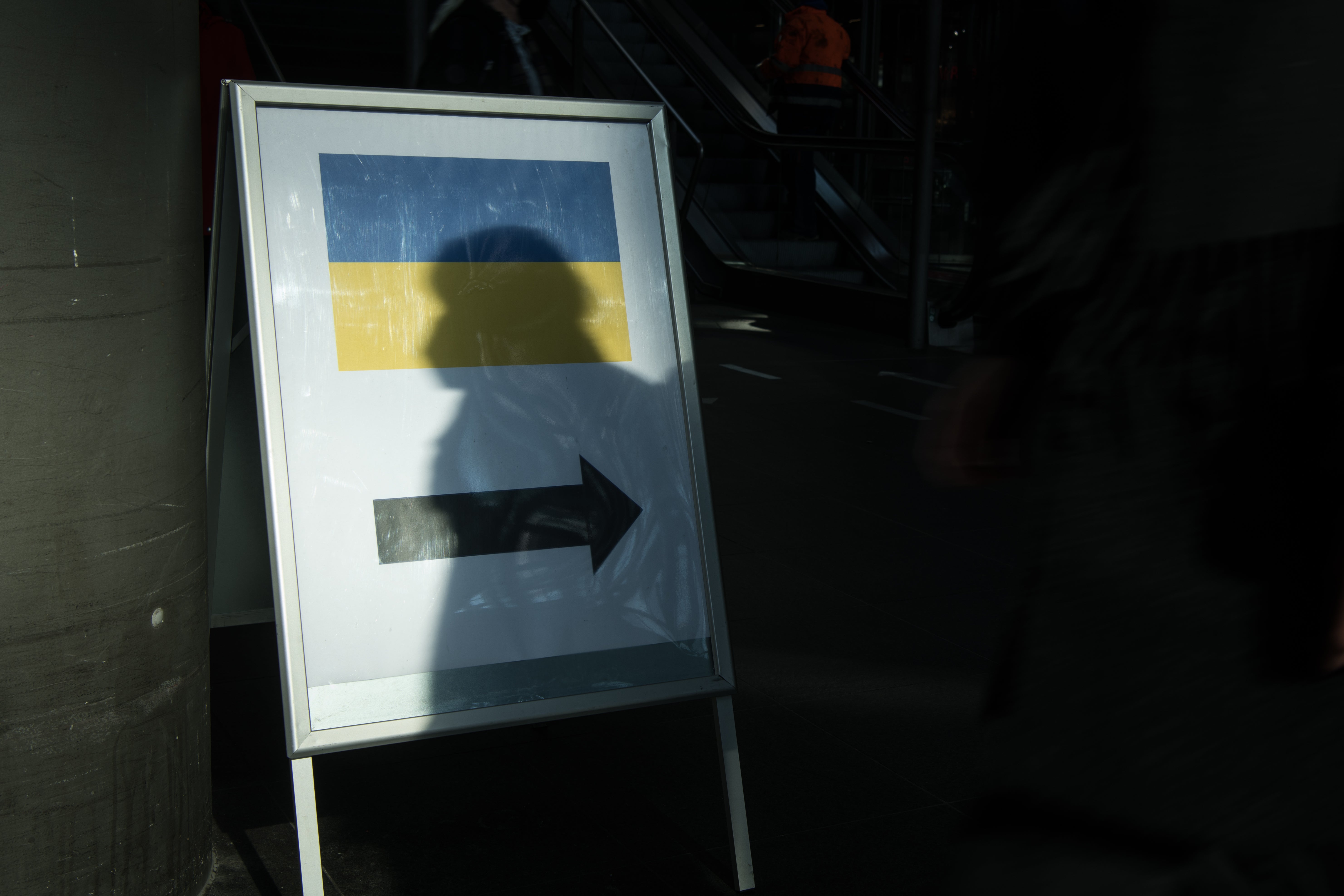 File photo: a sign in the form of a Ukrainian flag points the way to the offers of help for people fleeing Ukraine in Berlin