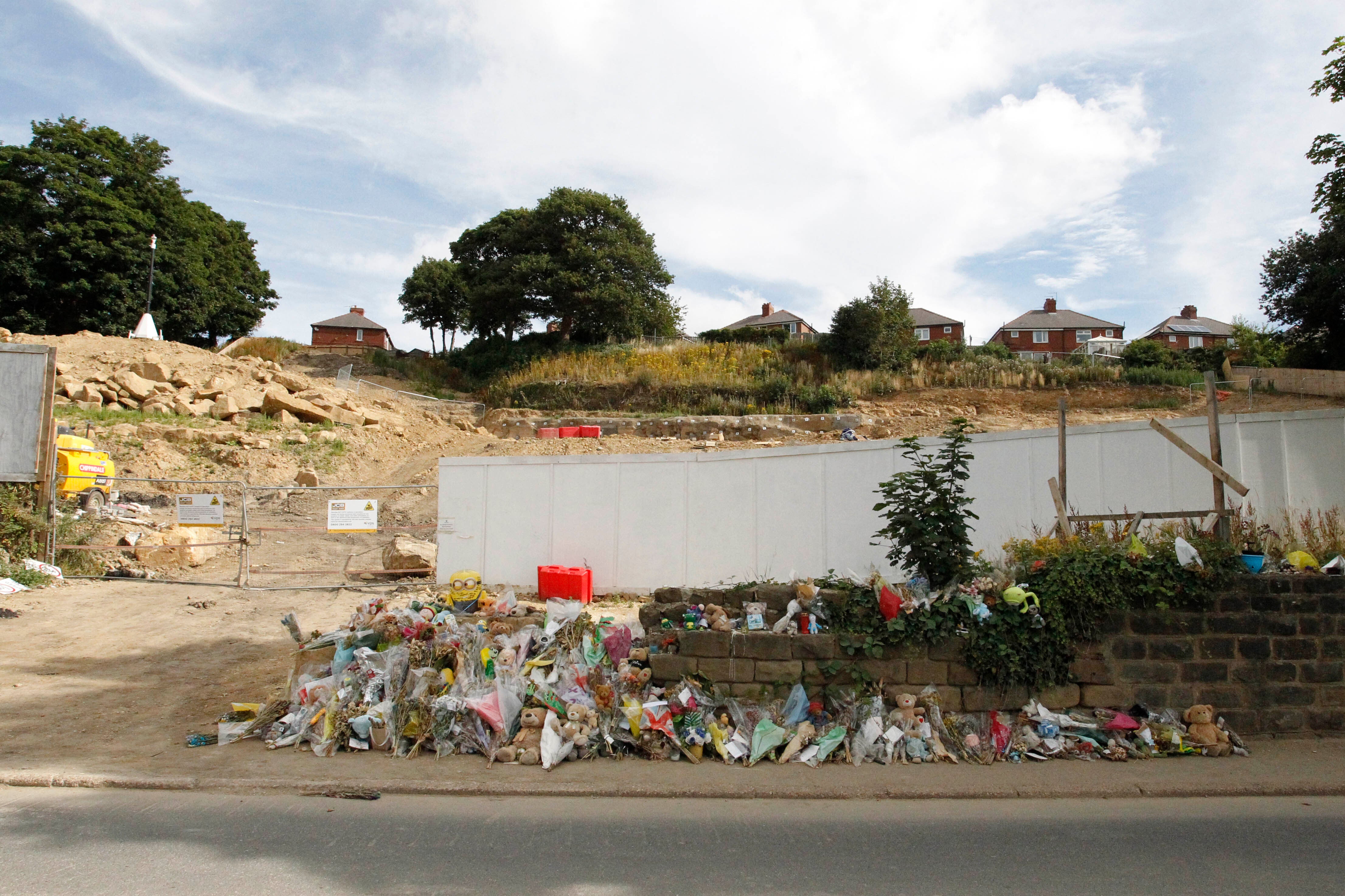 Floral tributes outside the building site