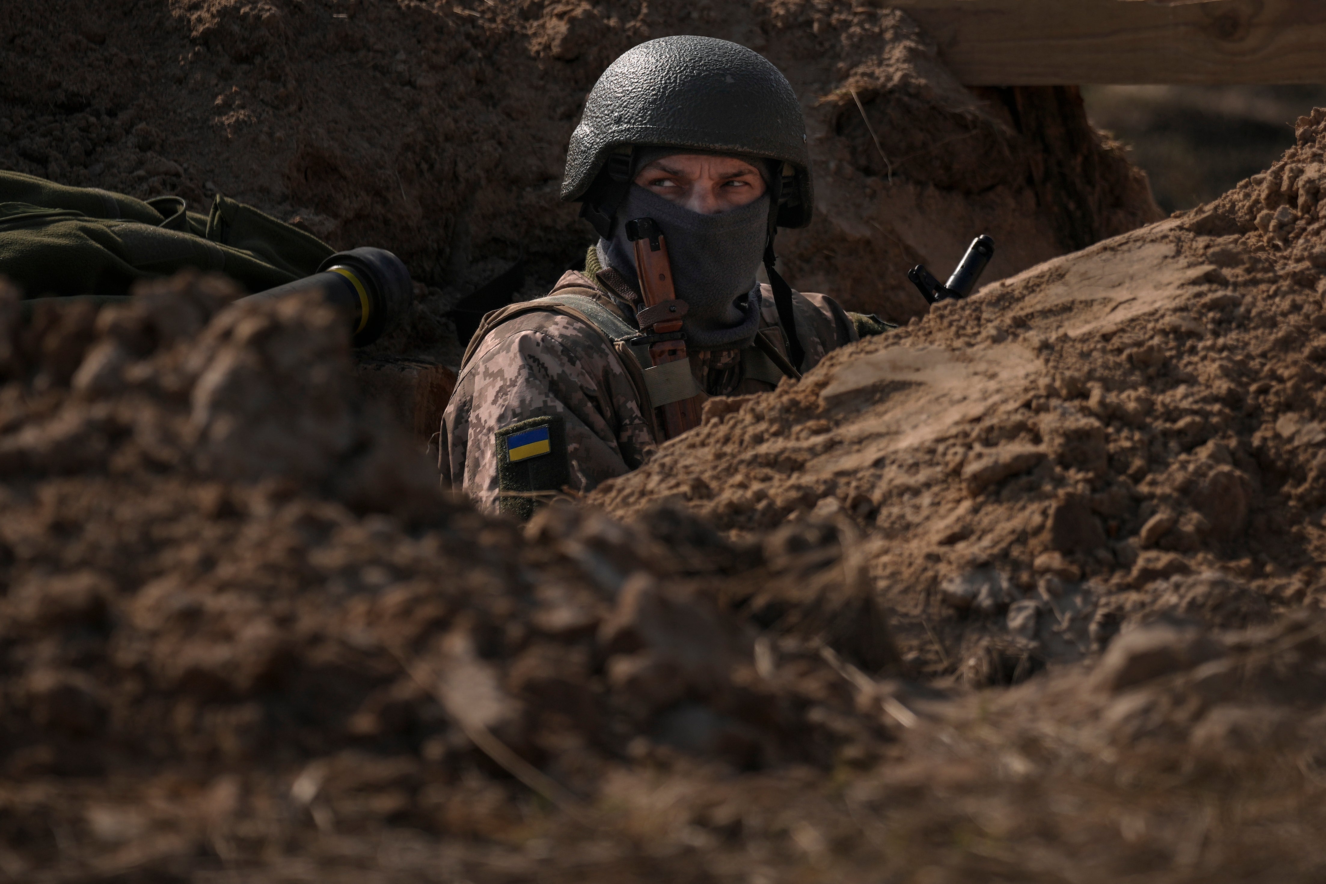 A Ukrainian soldier in trenches north of the capital Kyiv