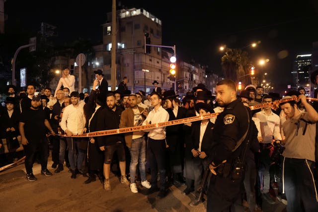 <p>A crowd gathers to watch police operations after a gunman opened fire in Bnei Brak, Israel</p>