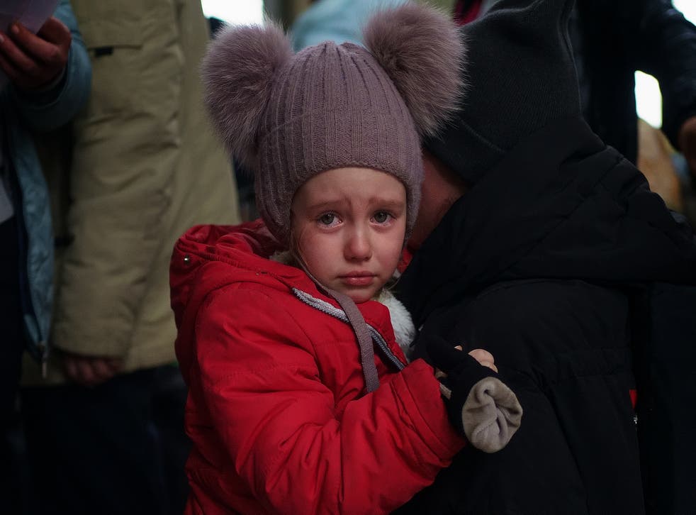A young Ukrainian refugee cries on the shoulder of her mother (Victoria Jones/PA)