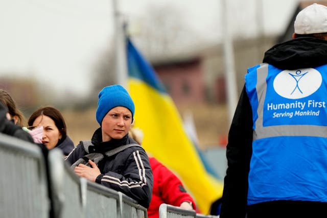 Refugees wait in a queue after fleeing the war in Ukraine (Sergei Grits/AP)