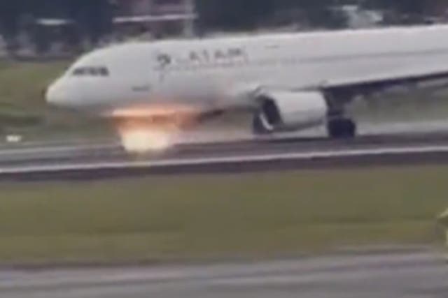 <p>Sparks fly from the Latam aircraft</p>