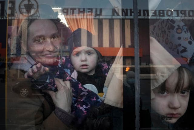 <p>Internally displaced people look out from a bus at a refugee center in Zaporizhia, Ukraine</p>
