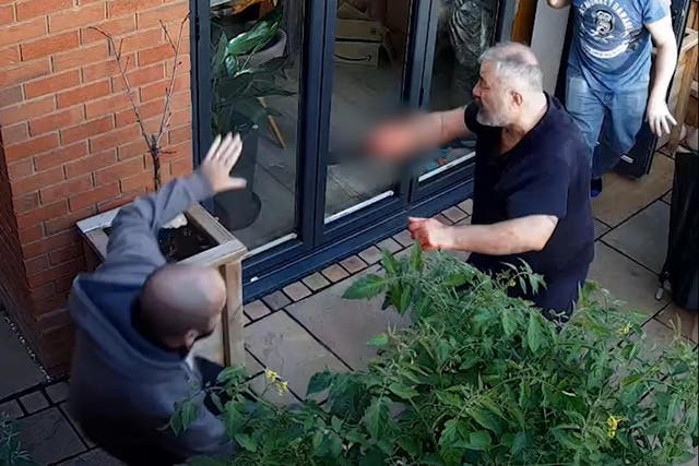 Still from CCTV issued by Gloucestershire Police of Can Arslan at the home of Peter Marsden in Walton Cardiff, with off-duty officer, Sergeant Steve Wilkinson (left) (Gloucestershire Police/PA)
