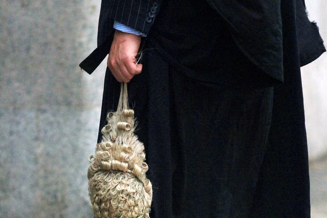 Detail view of a barrister holding a legal wig (Clara Molden/PA)