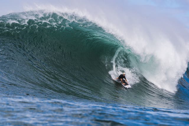 <p>Koa Smith surfs Waimea Bay in the Hawaiian island of Oahu</p>