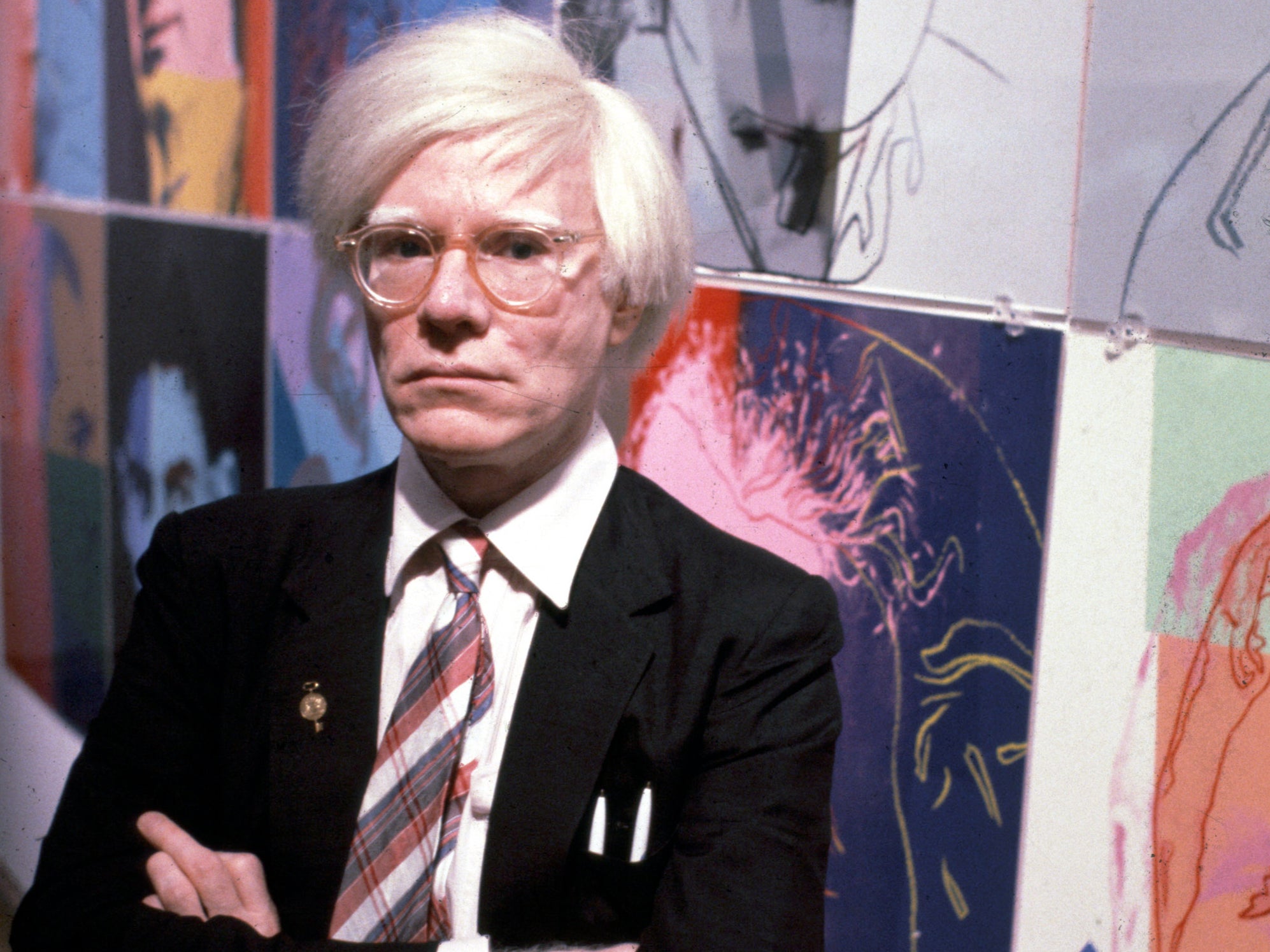 Andy Warhol with some of his works on 15 December 1980