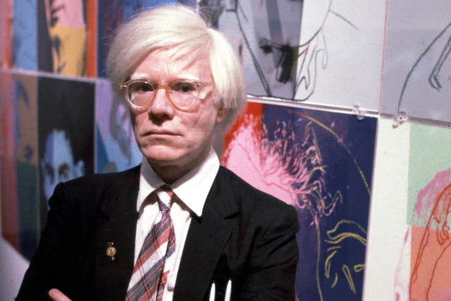 <p>Andy Warhol with some of his works on 15 December 1980</p>