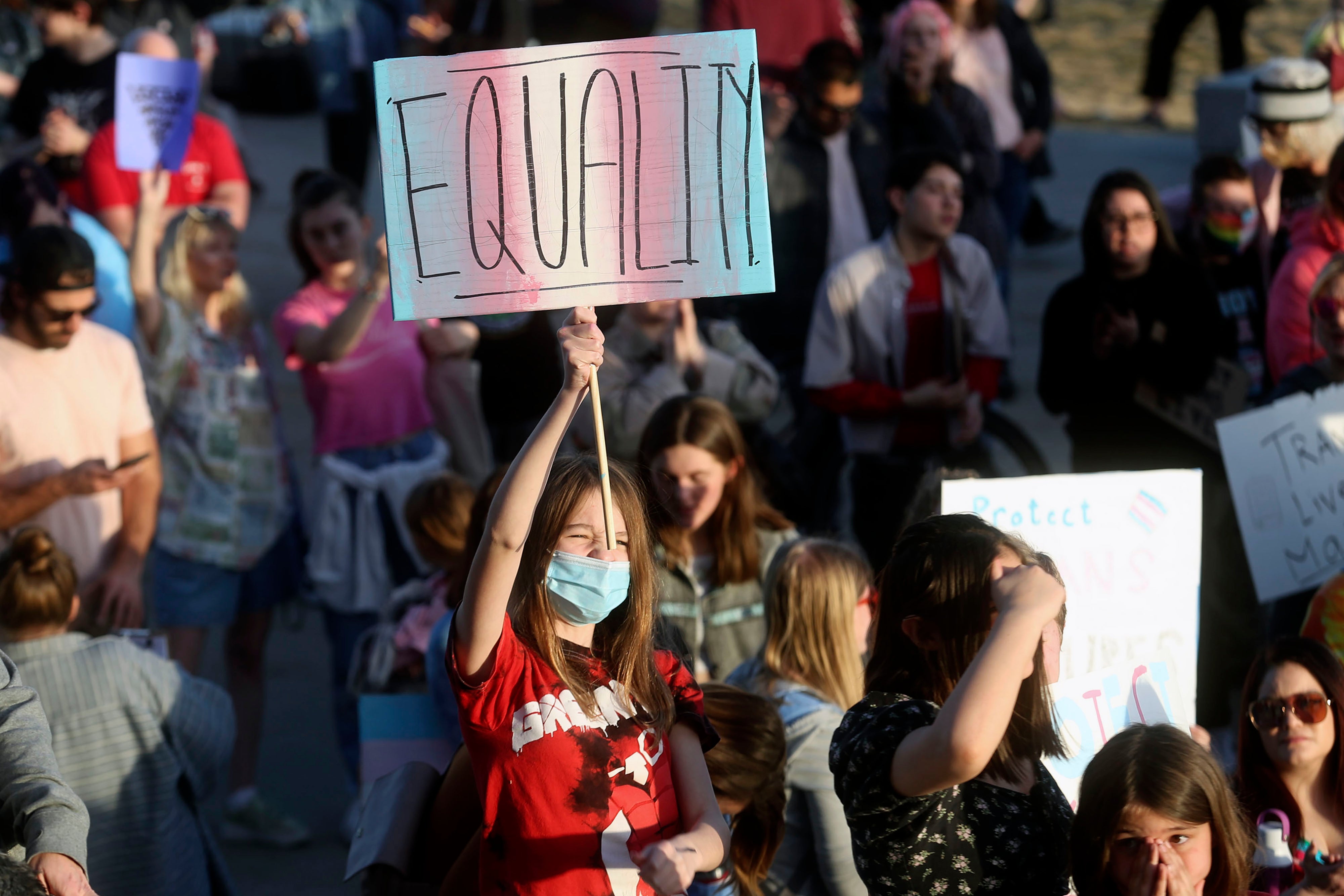 A young protester urges Utah legislators to reject legislation banning transgender athletes from women’s sports at a demonstration on 24 March.
