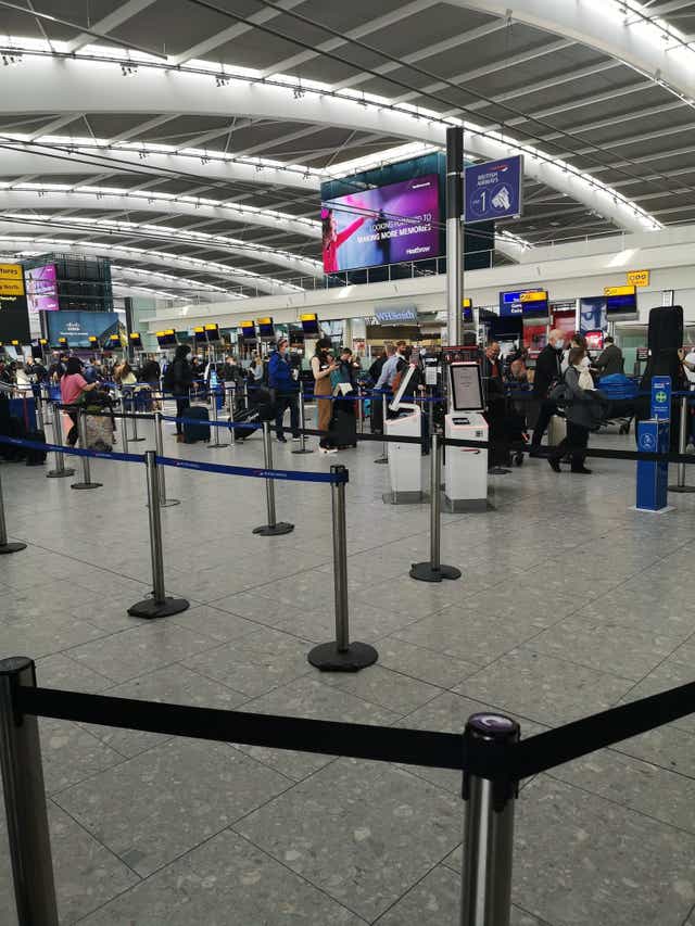 British Airways passengers in line to check in at Heathrow Airport on Wednesday afternoon (Michelle Heinrich/PA)