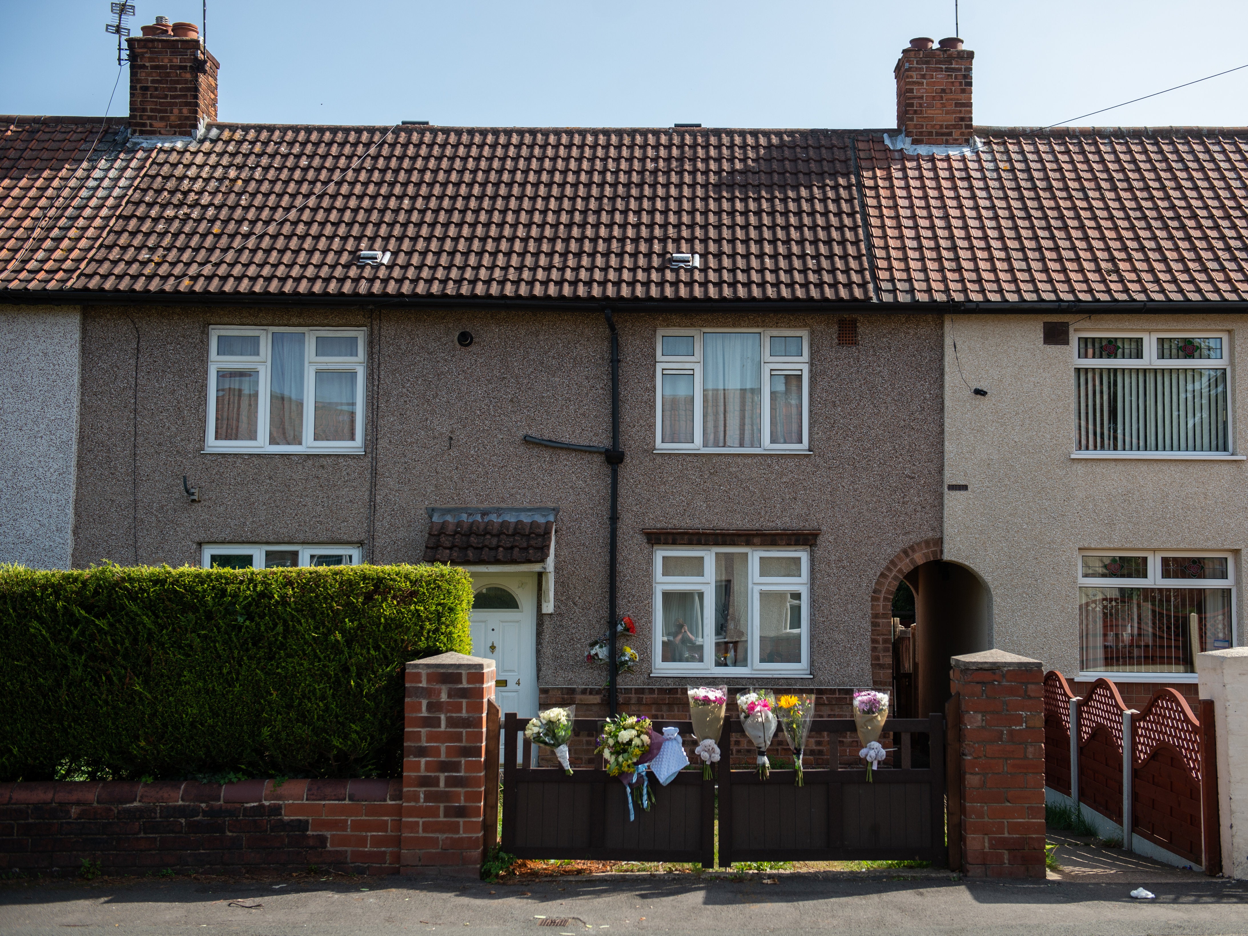 Dozens of flowers were left outside the family home in Doncaster after 12-day-old Elon Ellis-Joynes was killed in a dog attack