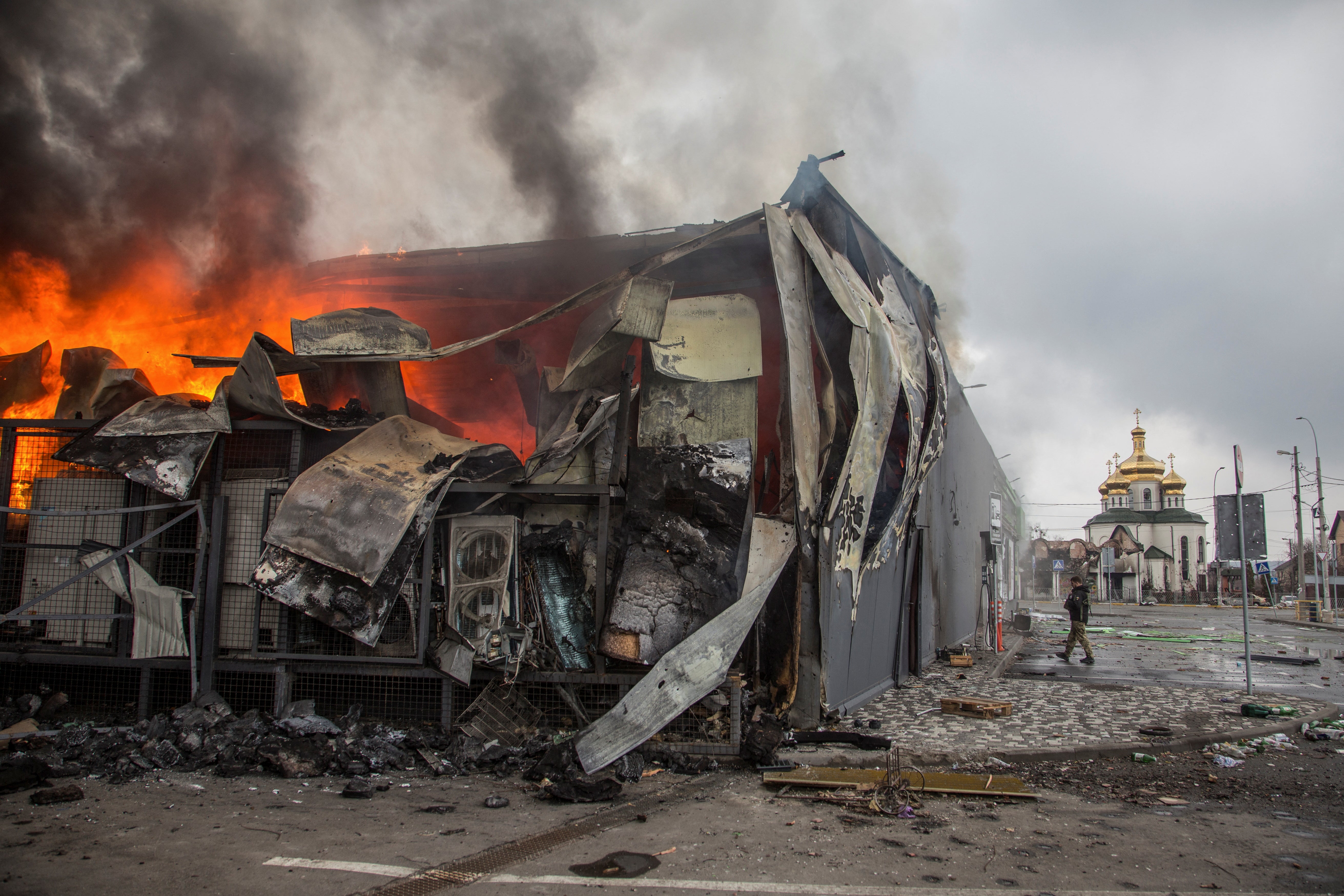 A building burns in Irpin, Ukraine, as Russia continues to bombard its neighbour