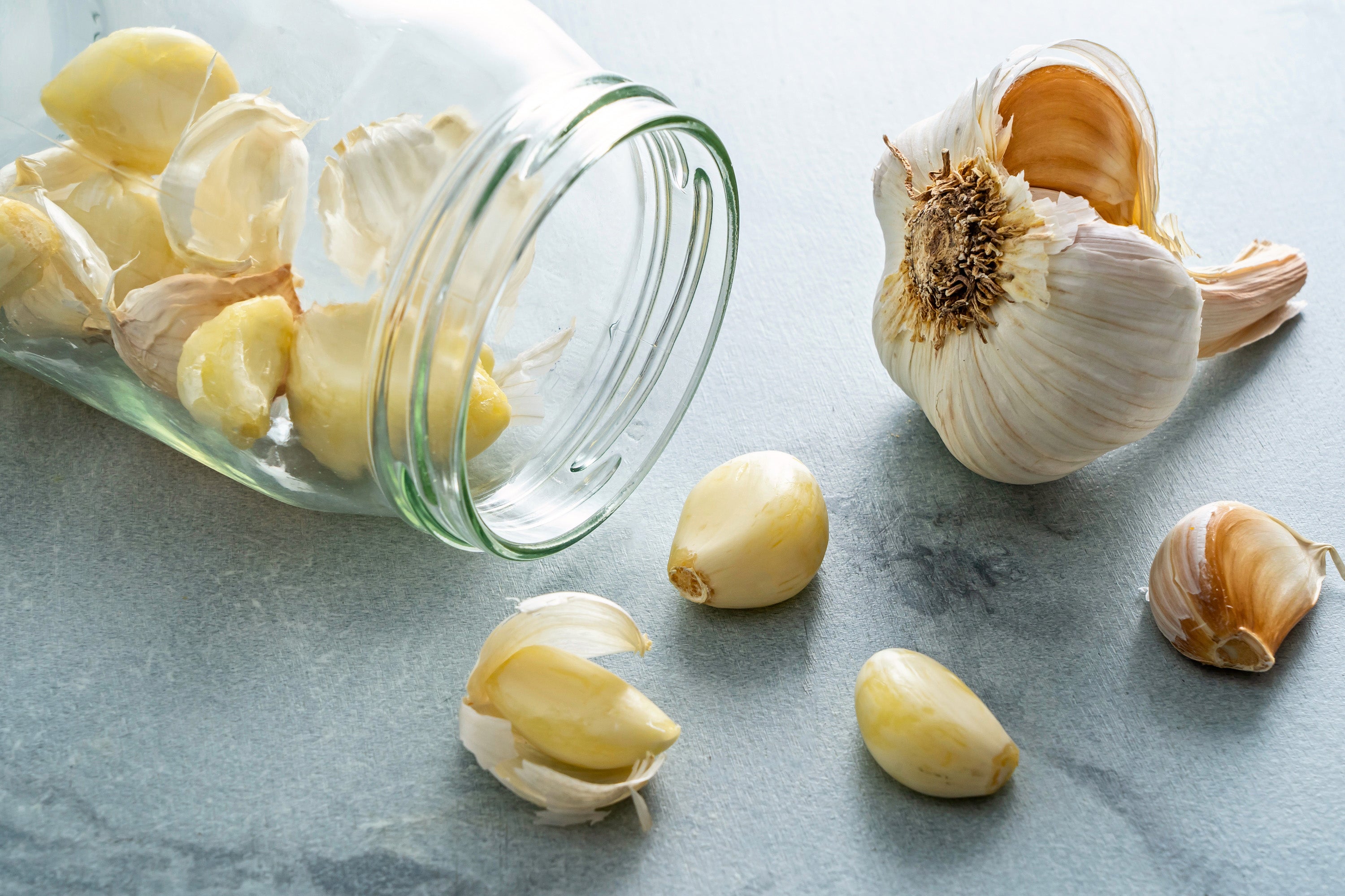 To remove garlic's papery skin, place the cloves in a large, clean, dry jar with a hard lid and shake vigorously for 15 to 20 seconds
