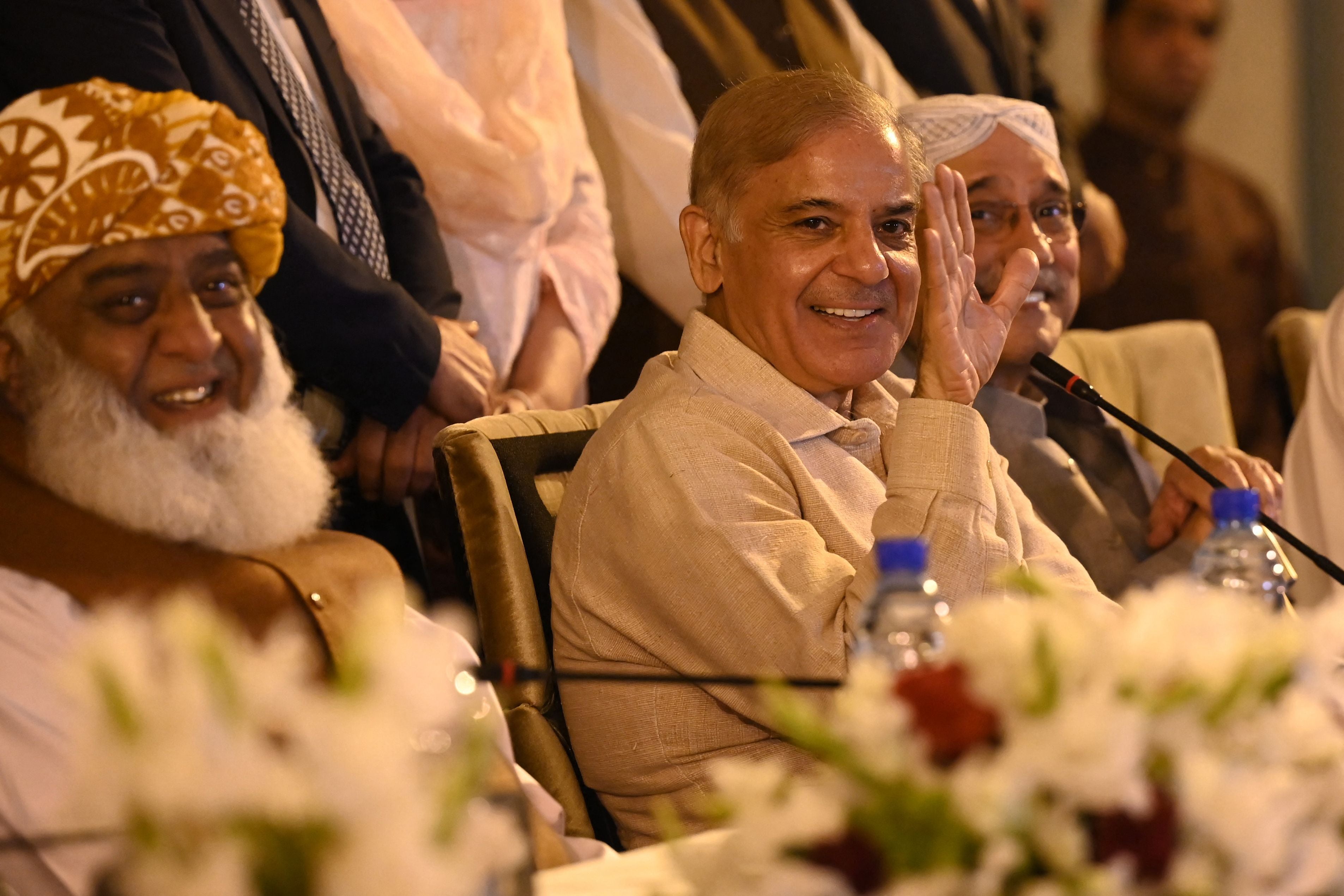 Pakistan’s opposition parties leaders Shehbaz Sharif (centre), Asif Ali Zardari (right) and Fazlur Rehman (left) speak during a press conference in Islamabad